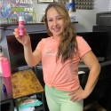 Customer holding painzen lotion bottle with smile, raving about how great painzen works for athletes